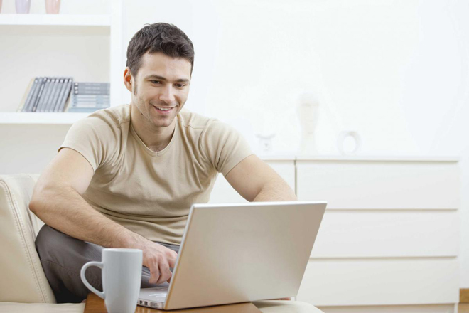 smiling man at laptop